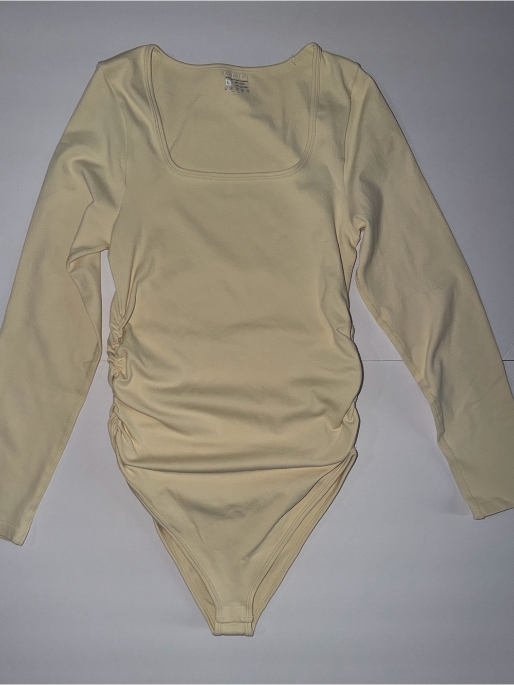 Kids Long-Sleeve One-Piece Bodysuit in Pale Yellow